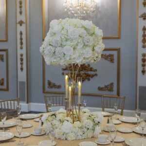 White Hydrangea and Rose On Gold Hourglass Stand with Gold Taper Candle Holders and Wreath