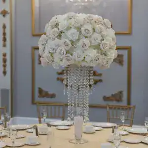 Elegant floral centerpiece with roses and crystal accents for luxury event rentals.
