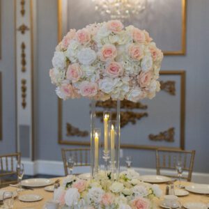 White Hydrangea with white and blush roses on Clear Harlow Stand with Taper Candle holders and Wreath