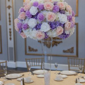 Elegant floral centerpiece for wedding or event decor, featuring roses and hydrangeas in soft pastel colors.