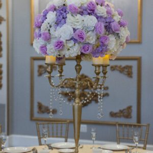 Pink and white floral centerpiece with candlelit accents for elegant event decor.