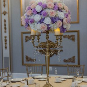 Elegant floral centerpiece with roses and hydrangeas for wedding rentals.