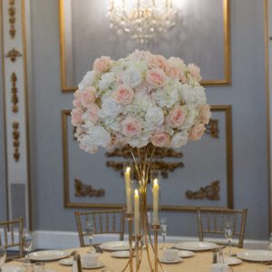White Hydrangea with white and blush roses on Gold Hourglass Stand with Flameless Taper Candle holders
