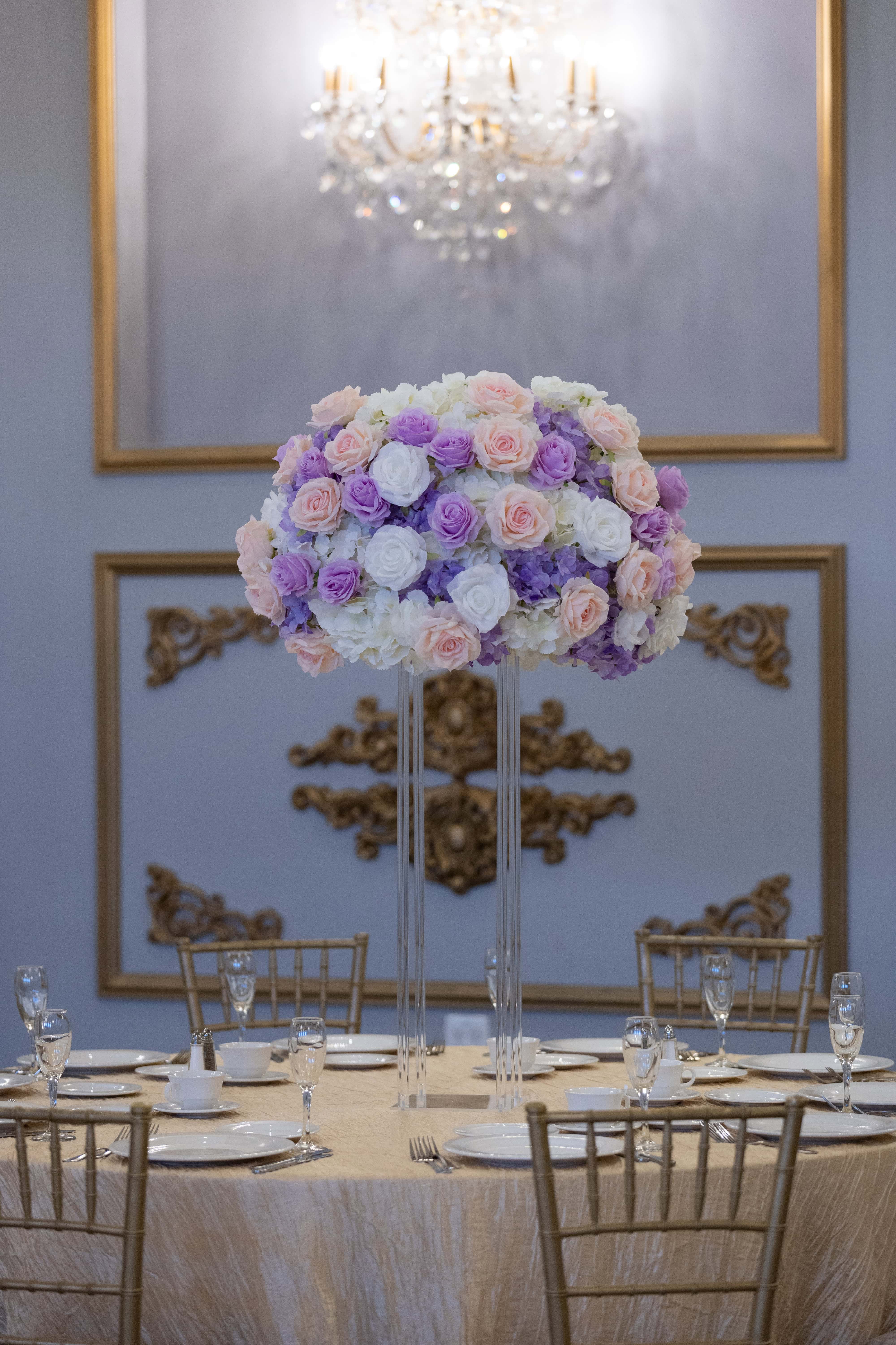 Elegant floral centerpiece with pastel roses for event decor at Amore Decor Rental.