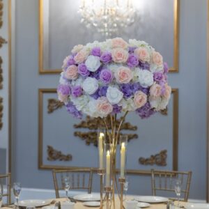 White Hydrangea with white, pink and lavender roses on gold hourglass stand with taper candle holders