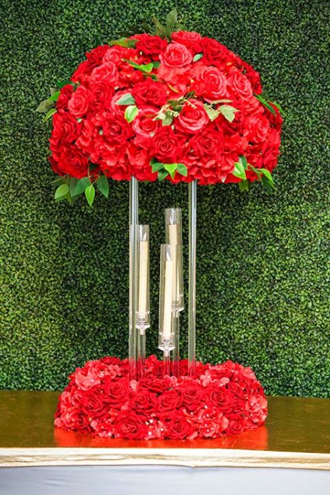 Red-Hydrangea-and-rose-with-greenery-on-clear-acrylic-stand-with-Red-floral-wreath-and-tapper-candles-Centerpiece-Amore-Decor-Rental-125